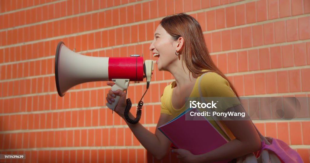  a student shouting into a megaphone