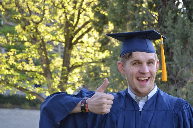 A confident nursing student smiling and holding a completed assignment, representing the sense of relief and accomplishment that comes with receiving assistance.