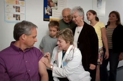 a nurse, a patient and his family interacting